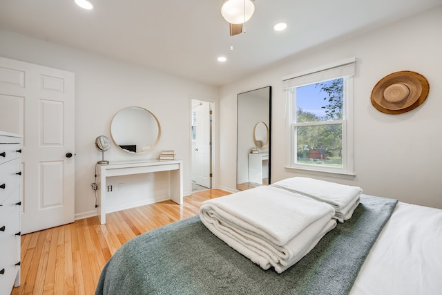 bedroom with hardwood / wood-style floors and ceiling fan