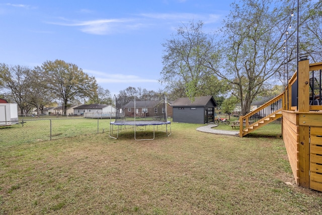 view of yard with a shed and a trampoline