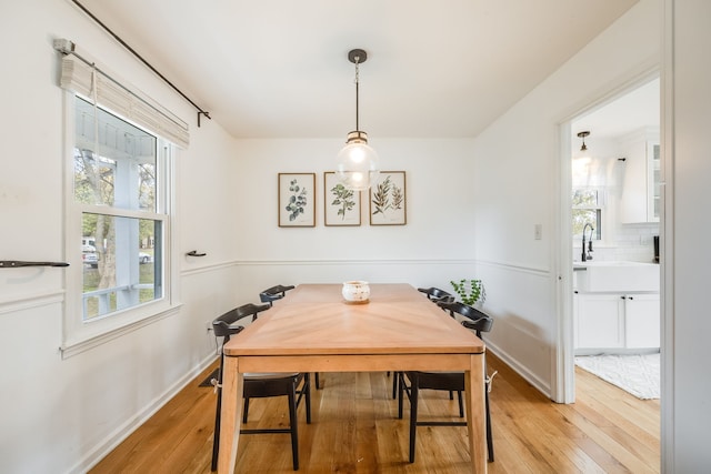 dining space featuring light hardwood / wood-style floors and sink