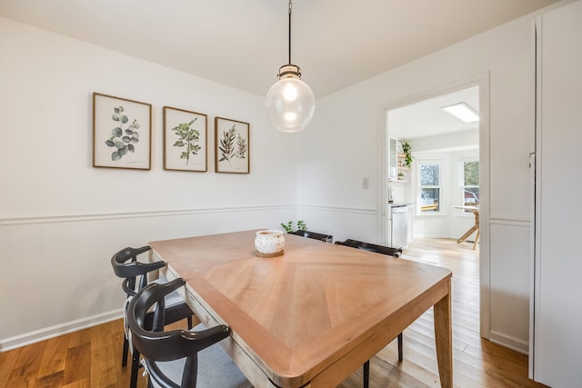 dining space with light hardwood / wood-style flooring