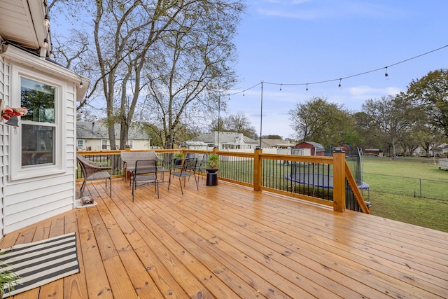 wooden deck featuring a yard