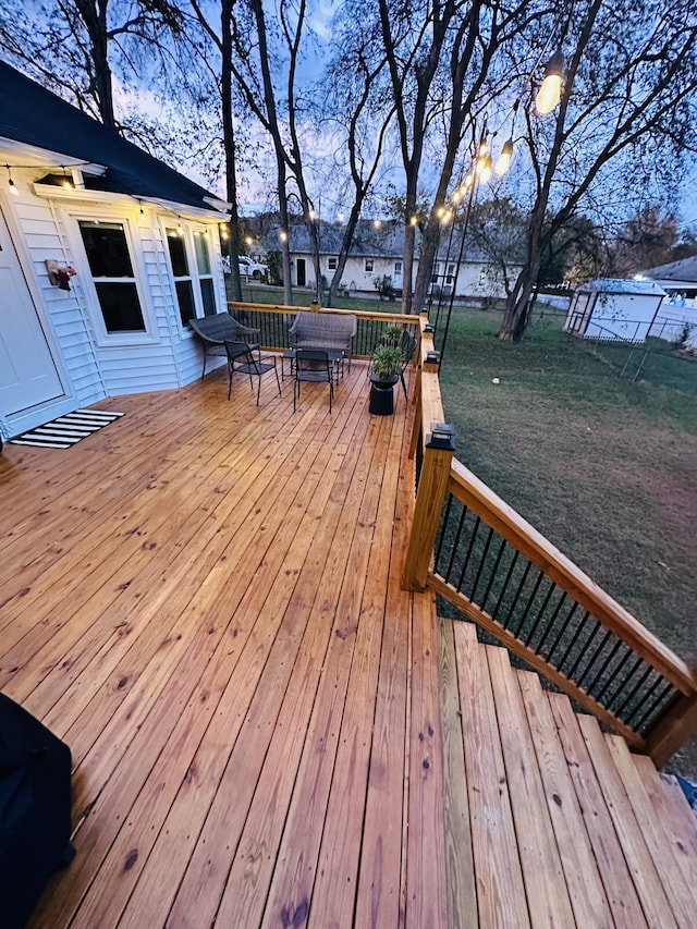 deck at dusk with a yard