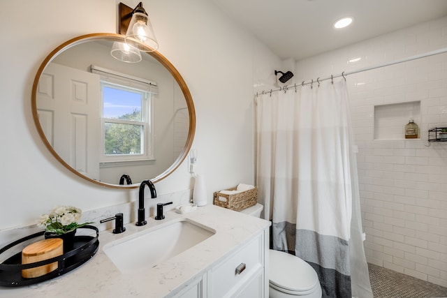 bathroom with toilet, vanity, and a shower with shower curtain