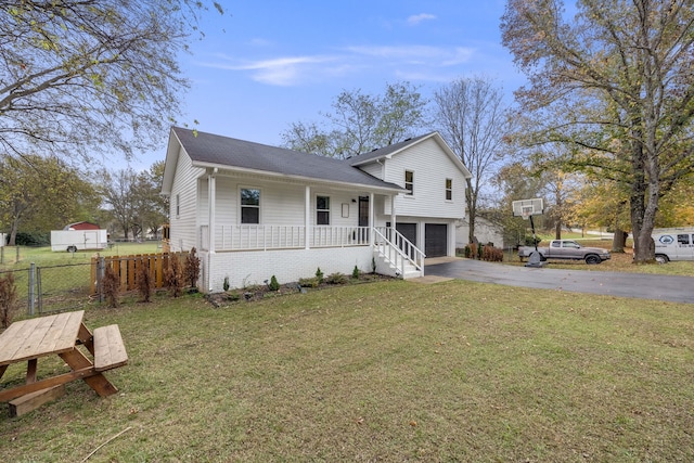 view of front of home featuring a garage, a front lawn, and a porch