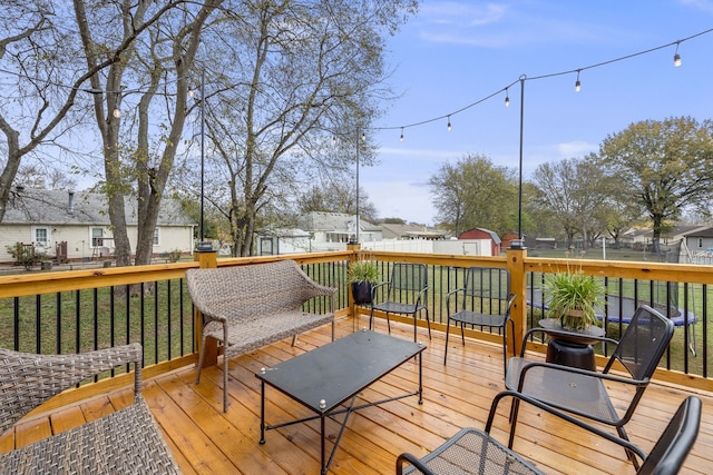 deck featuring a shed and a lawn