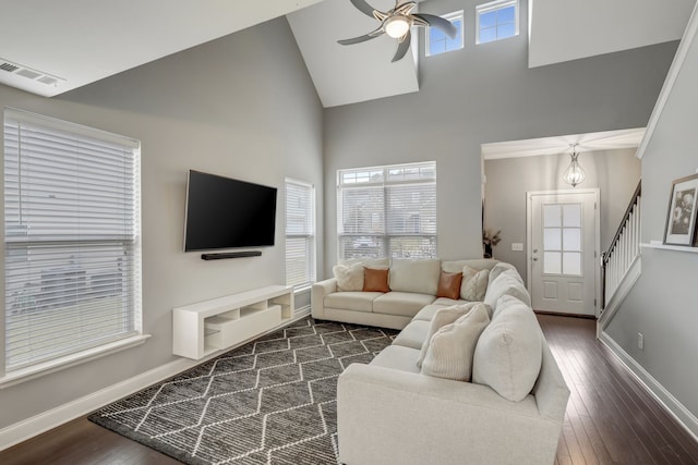 living room featuring dark hardwood / wood-style flooring, high vaulted ceiling, and ceiling fan