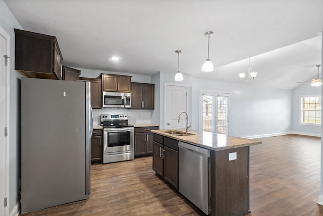 kitchen featuring stainless steel appliances, sink, decorative light fixtures, an island with sink, and dark wood-type flooring