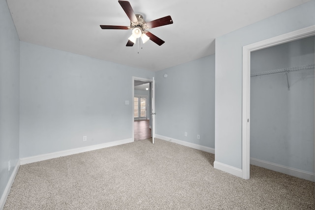 unfurnished bedroom with a closet, carpet flooring, and ceiling fan