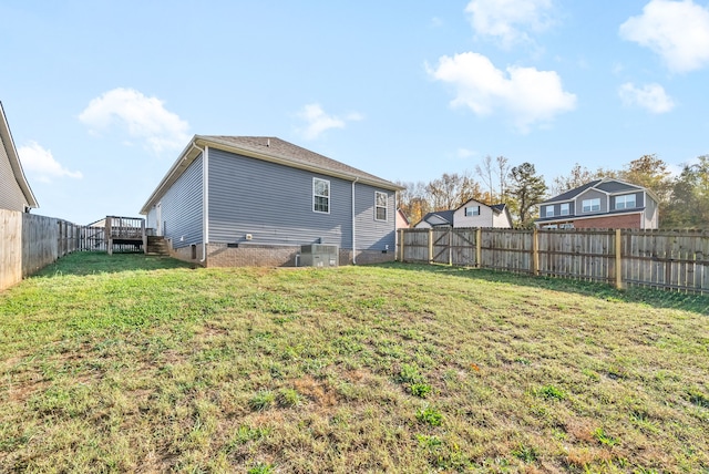 view of yard featuring central AC unit and a deck