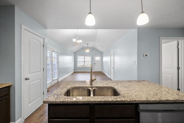 kitchen featuring decorative light fixtures, lofted ceiling, sink, and white dishwasher