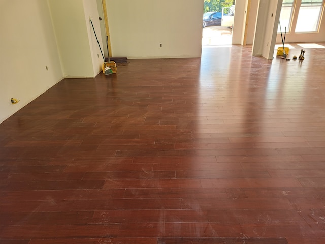 unfurnished room with a healthy amount of sunlight and dark hardwood / wood-style floors