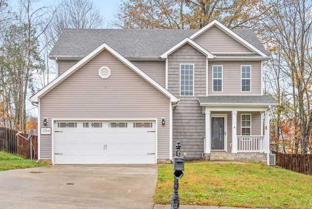 front facade featuring a garage, a front lawn, and covered porch