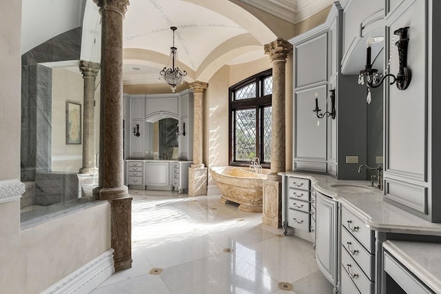 1050 Pine Creek Falls Rd, Smithville, TN 37166 - bathroom featuring decorative columns, two vanities, a tub to relax in, marble tiled flooring, and vaulted ceiling