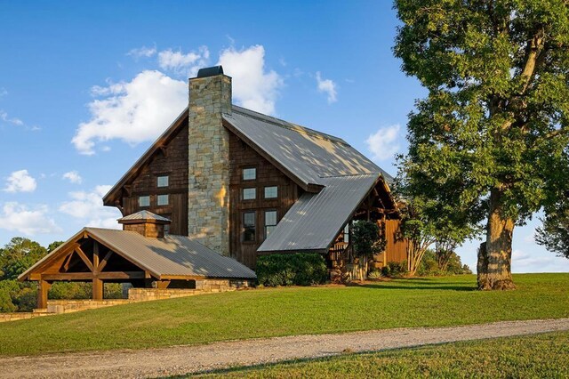 1050 Pine Creek Falls Rd, Smithville, TN 37166 - rear view of house featuring a chimney, a lawn, and metal roof