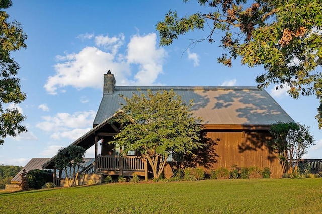 1050 Pine Creek Falls Rd, Smithville, TN 37166 - view of property exterior featuring a yard, metal roof, a chimney, and an outdoor structure