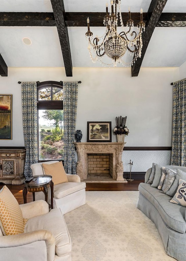 1050 Pine Creek Falls Rd, Smithville, TN 37166 - living room with beamed ceiling, a chandelier, wood finished floors, and a fireplace with raised hearth