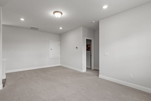 unfurnished room featuring light carpet