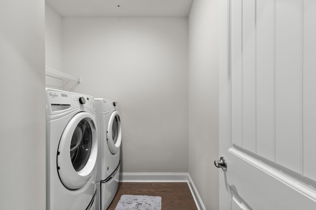 clothes washing area with washer and dryer and dark hardwood / wood-style floors