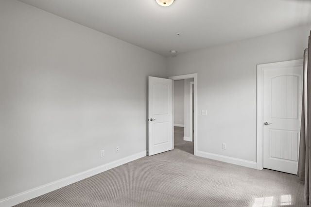 unfurnished bedroom featuring light colored carpet