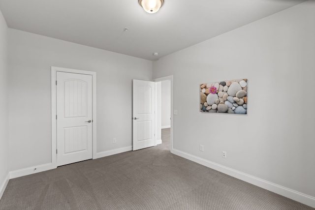 unfurnished bedroom featuring dark carpet