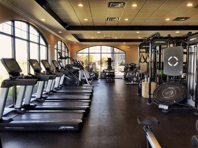 workout area with a drop ceiling and ornamental molding