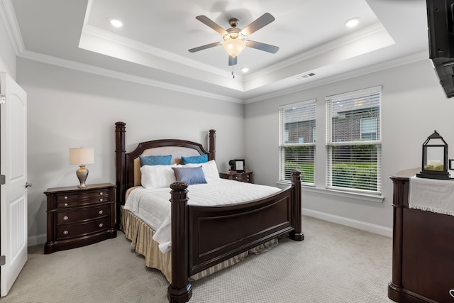 carpeted bedroom featuring ornamental molding, ceiling fan, and a tray ceiling