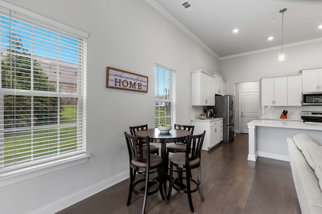 dining space featuring dark hardwood / wood-style floors and ornamental molding