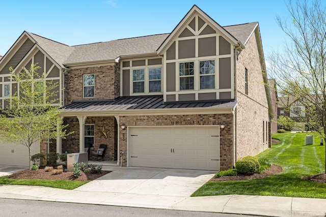 tudor-style house featuring a garage and a front lawn