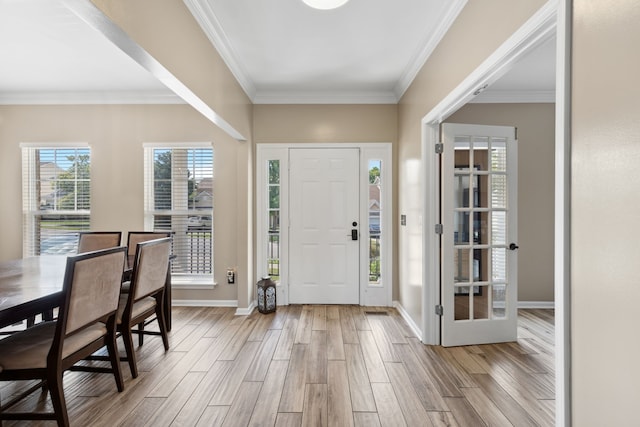 entryway with light hardwood / wood-style floors and ornamental molding