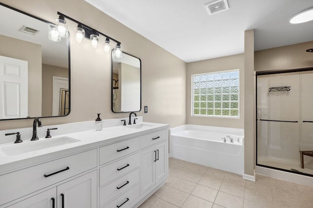 bathroom with plus walk in shower, vanity, and tile patterned floors