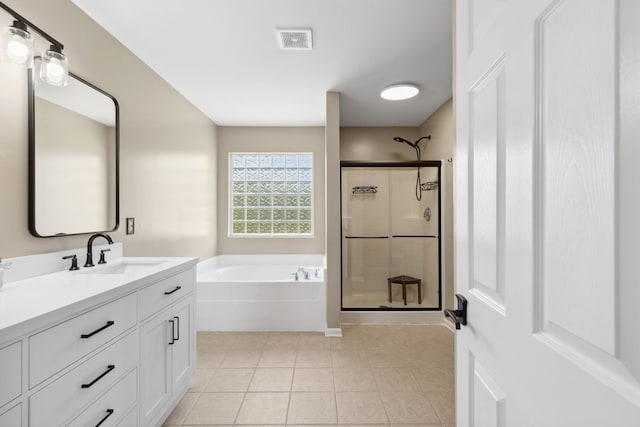 bathroom featuring tile patterned flooring, vanity, and separate shower and tub