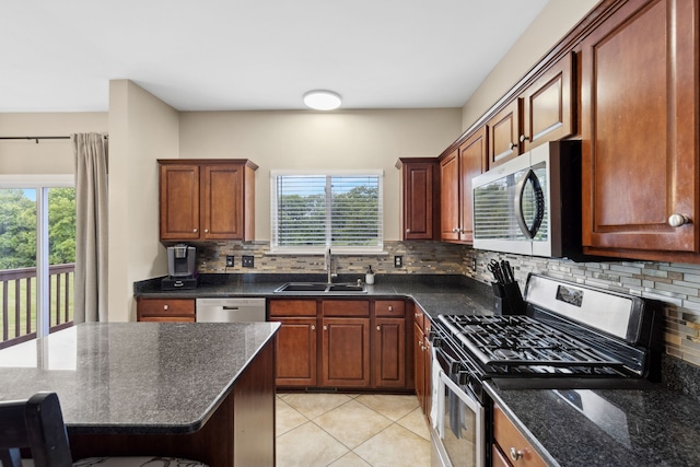 kitchen featuring stainless steel appliances, a wealth of natural light, sink, and tasteful backsplash