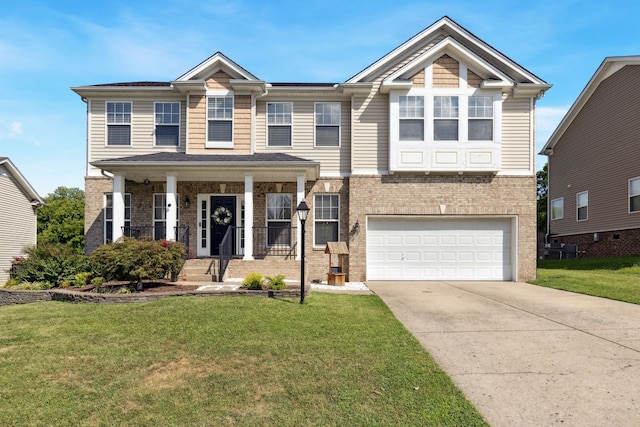 view of front of house featuring a garage, a front lawn, and a porch