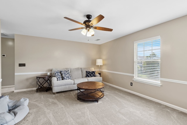 carpeted living room with ceiling fan