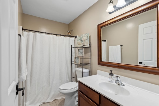 bathroom featuring toilet, vanity, and tile patterned flooring