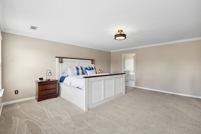 carpeted bedroom with ornamental molding and ensuite bathroom