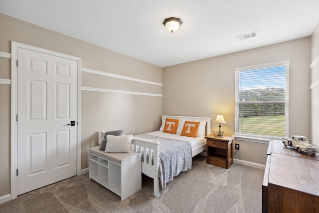 bedroom featuring light carpet