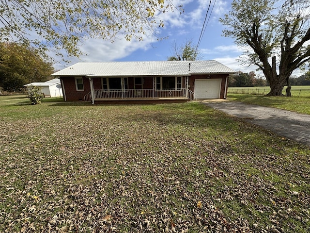 ranch-style home featuring a garage, a porch, and a front yard