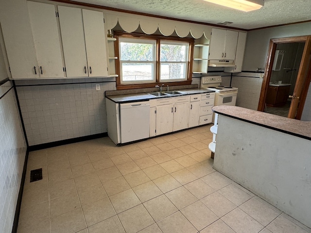 kitchen with tile walls, a textured ceiling, sink, white cabinetry, and white appliances