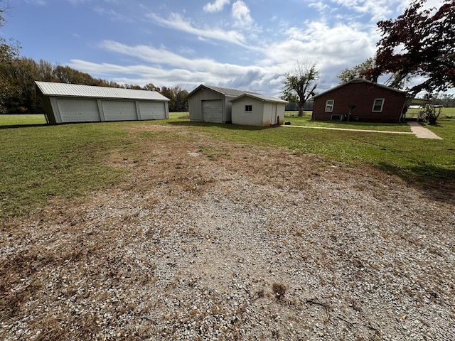 view of yard with a garage and an outdoor structure