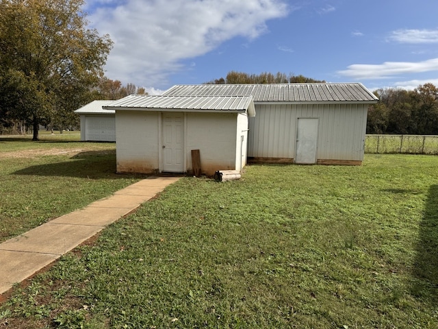 exterior space with a storage shed and a lawn