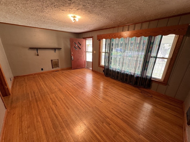 unfurnished room featuring a textured ceiling and hardwood / wood-style flooring