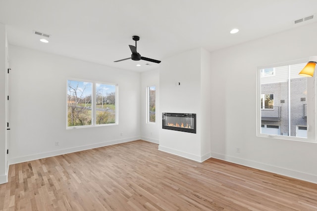 unfurnished living room with ceiling fan and light wood-type flooring