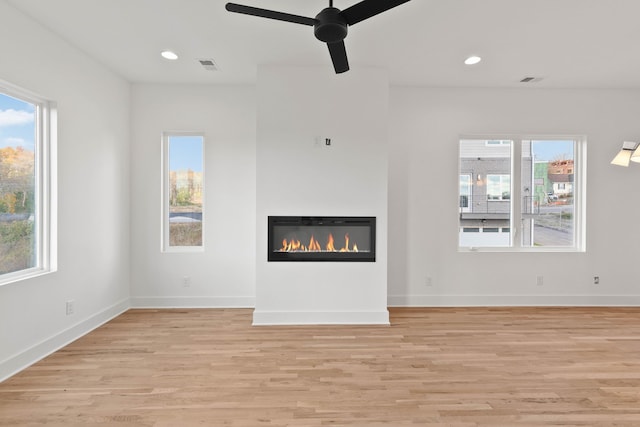 unfurnished living room with ceiling fan and light wood-type flooring