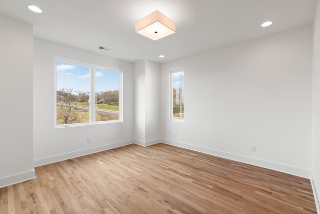 unfurnished room with light hardwood / wood-style floors