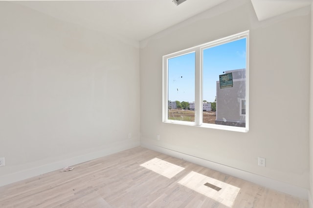 spare room with light hardwood / wood-style flooring