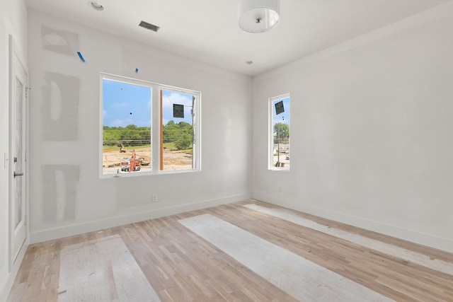 spare room with light hardwood / wood-style flooring