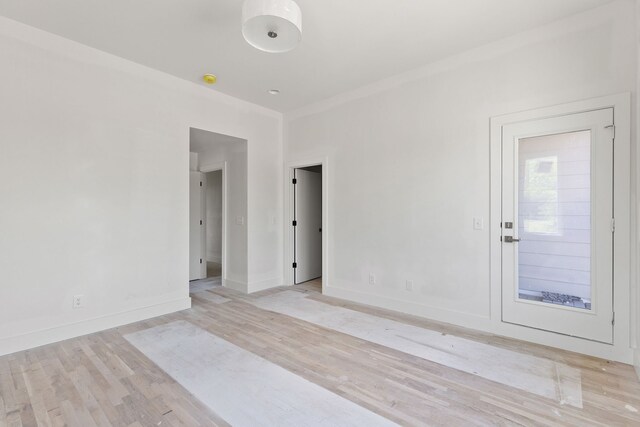 empty room with light hardwood / wood-style floors