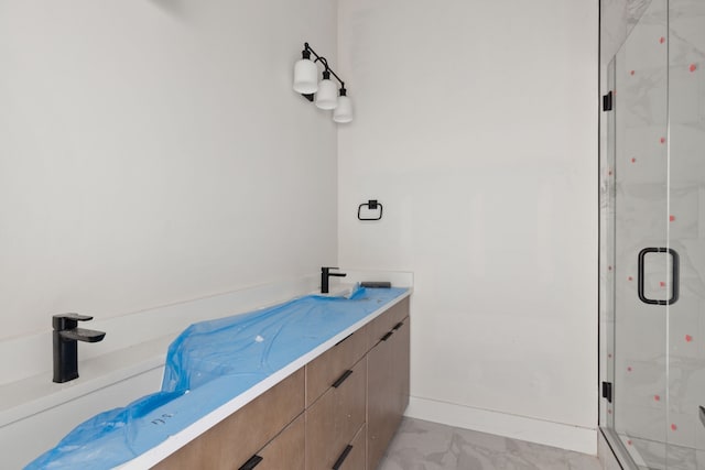 bathroom featuring vanity and a shower with door