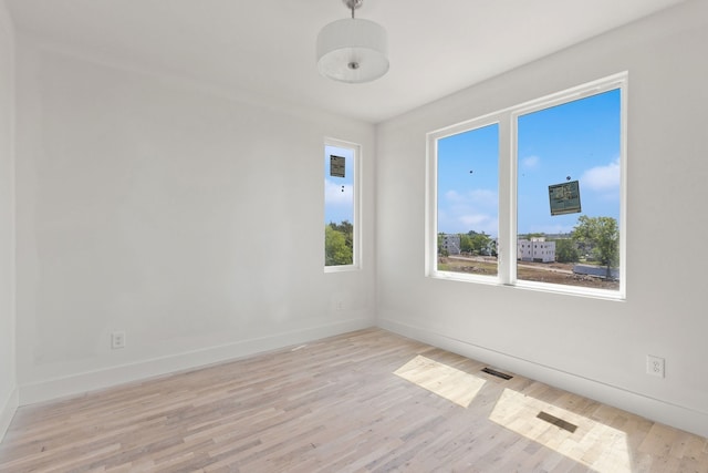 spare room with light hardwood / wood-style floors